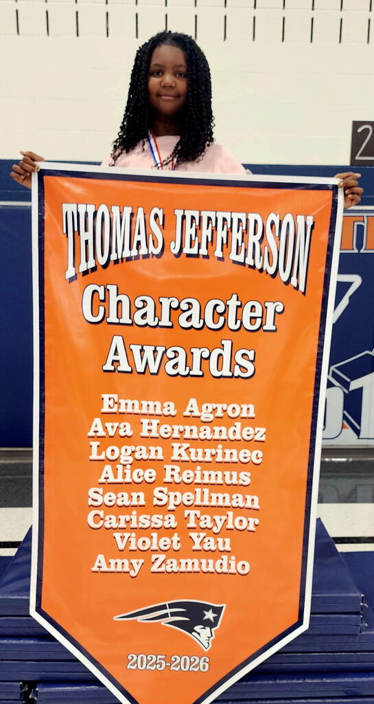 A student holding a banner. 