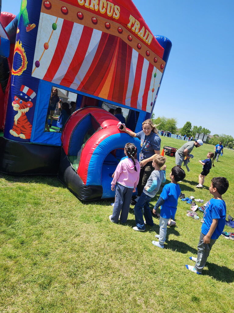 Students waiting in line at an inflatable bounce house. 