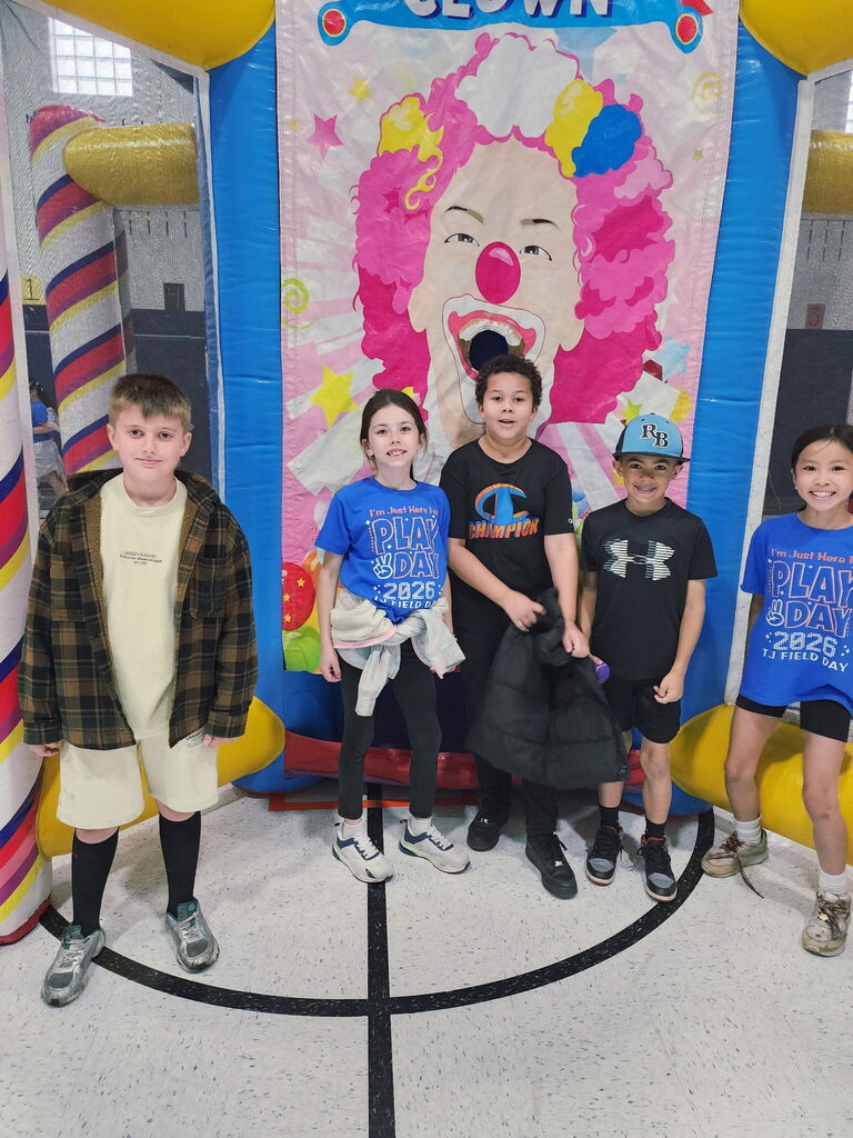 Students standing in front of a clown. 