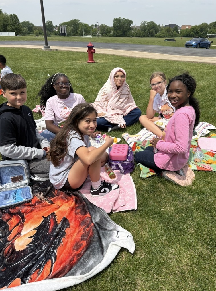 Students sitting outside having a picnic. 