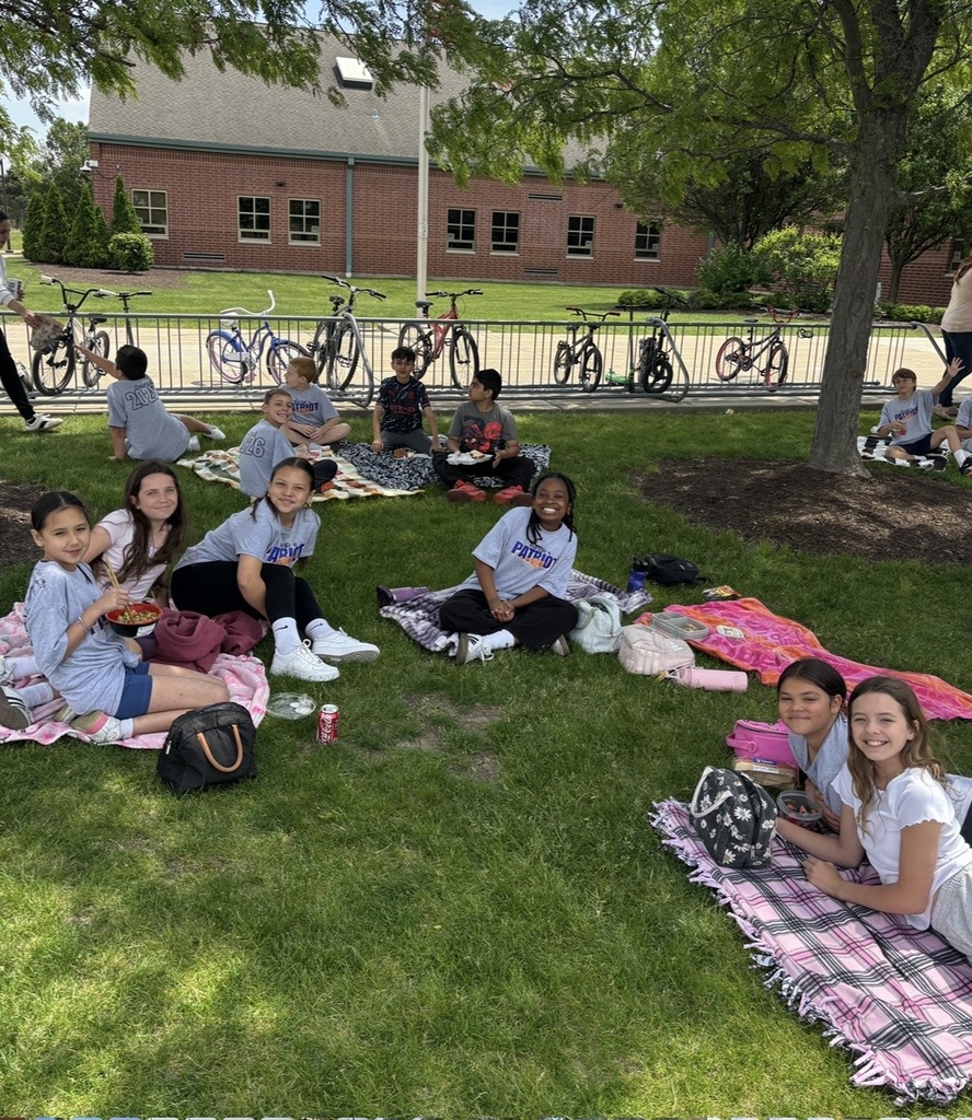 Students sitting outside having a picnic. 
