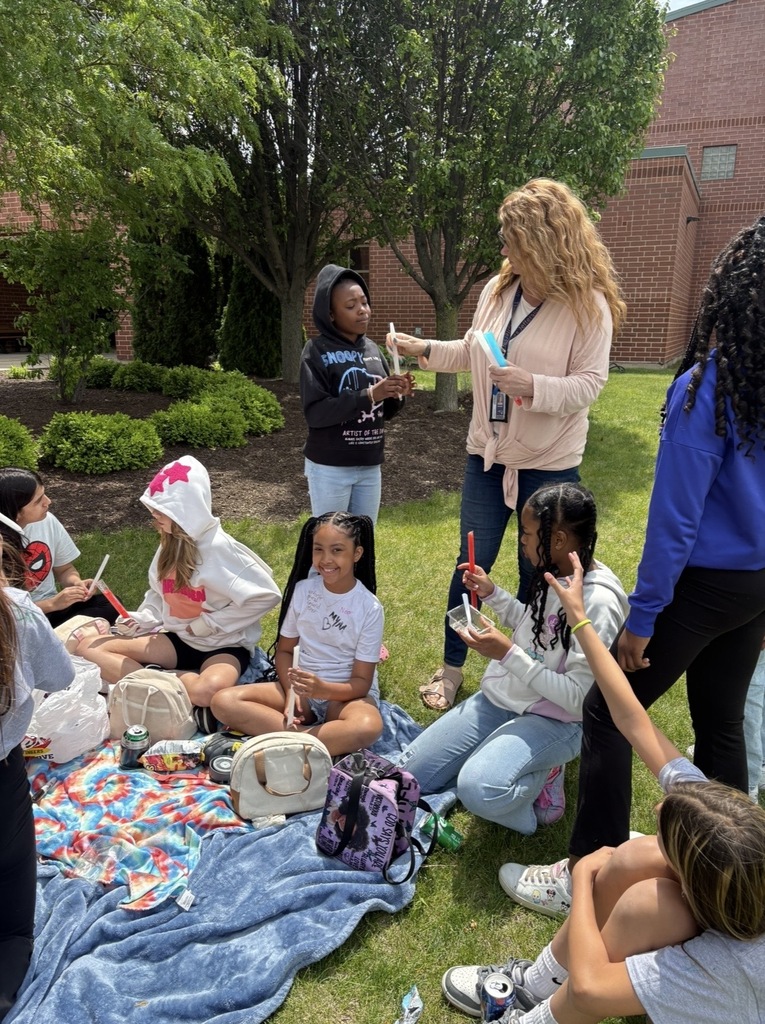 Students sitting outside having a picnic. 