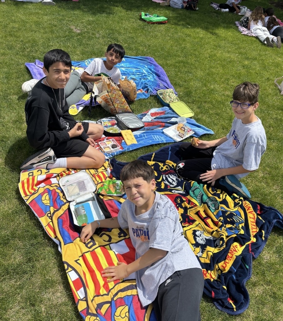 Students sitting outside having a picnic. 
