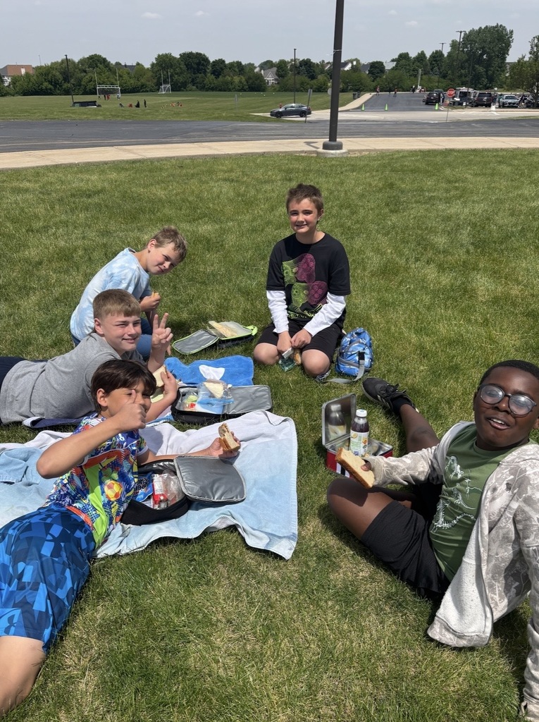 Students sitting outside having a picnic. 