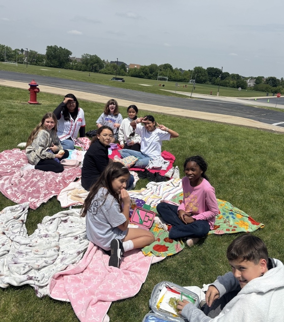 Students sitting outside having a picnic. 