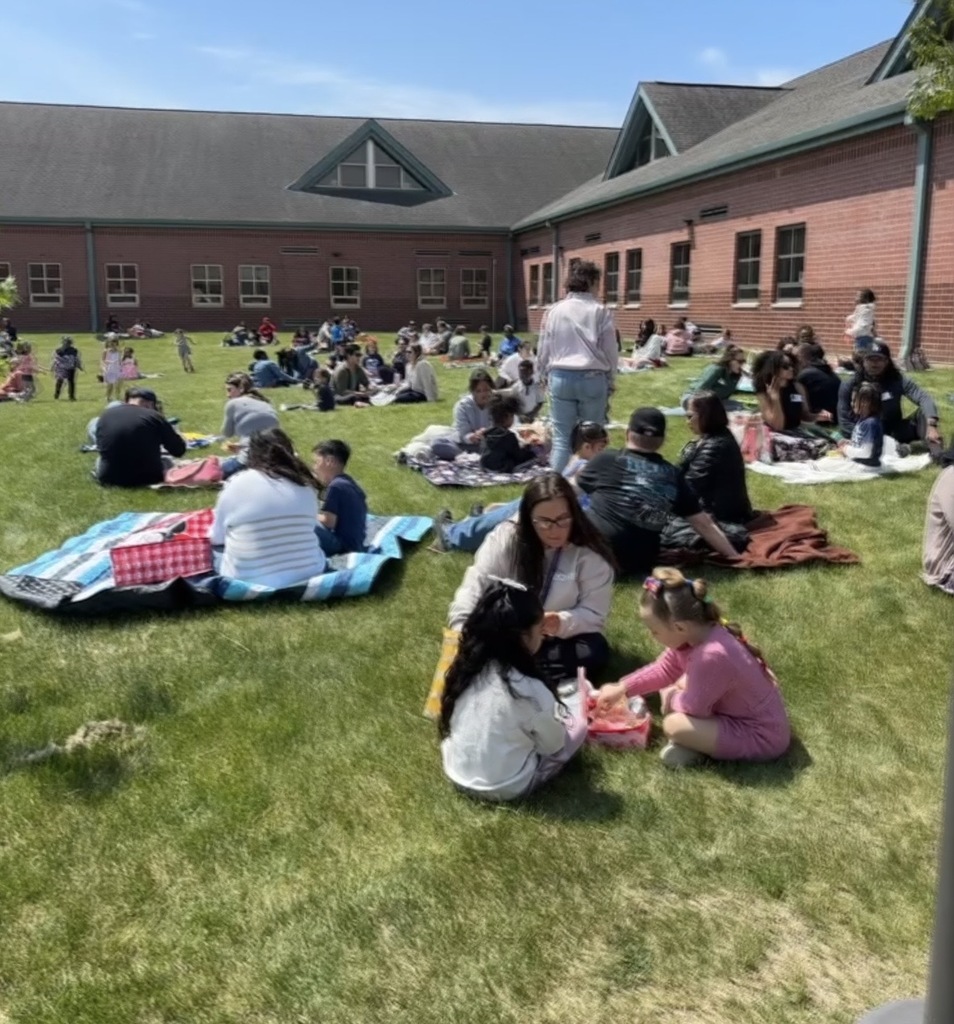 Students sitting outside having a picnic. 