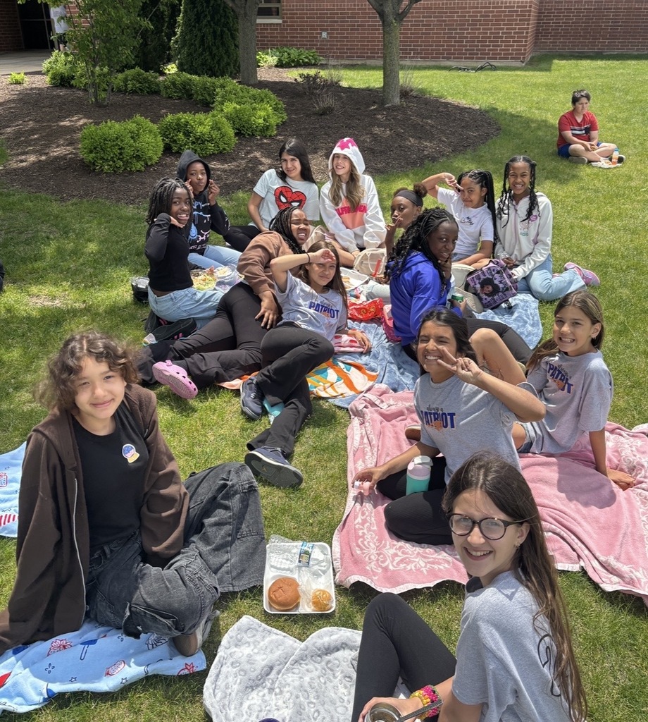 Students sitting outside having a picnic. 