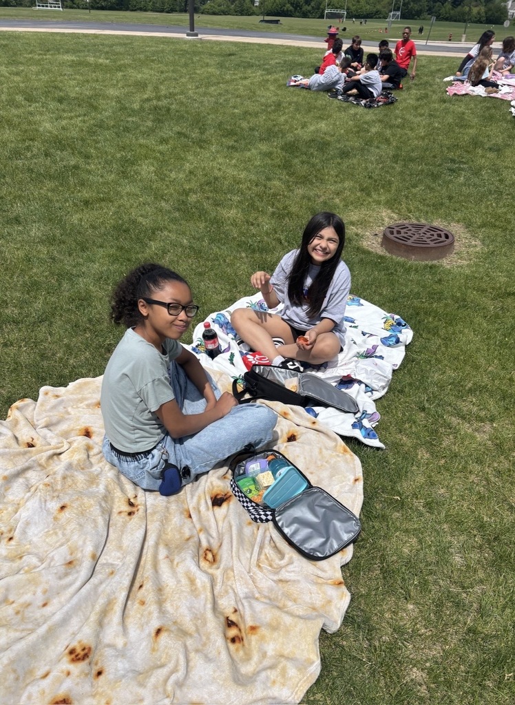 Students sitting outside having a picnic. 