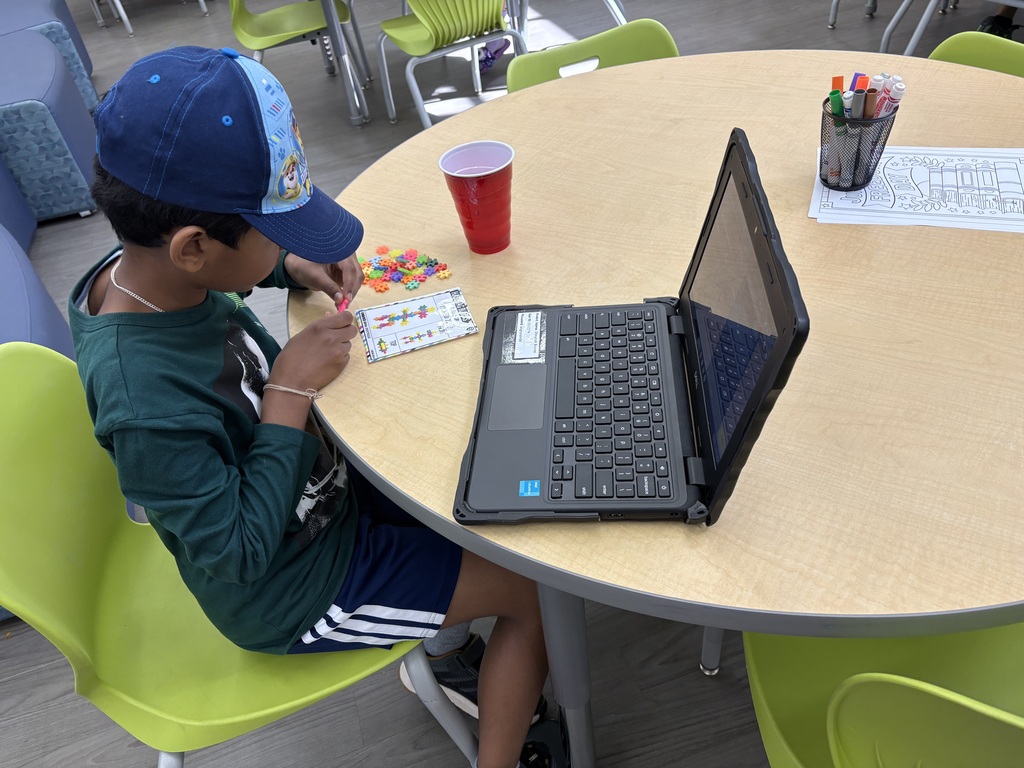 student wearing basebal hat builds with color blocks