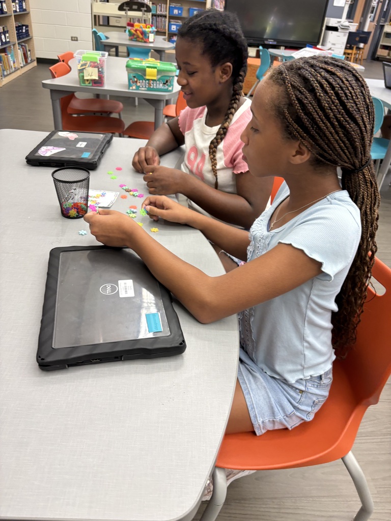 two female students build with colorful small  blocks