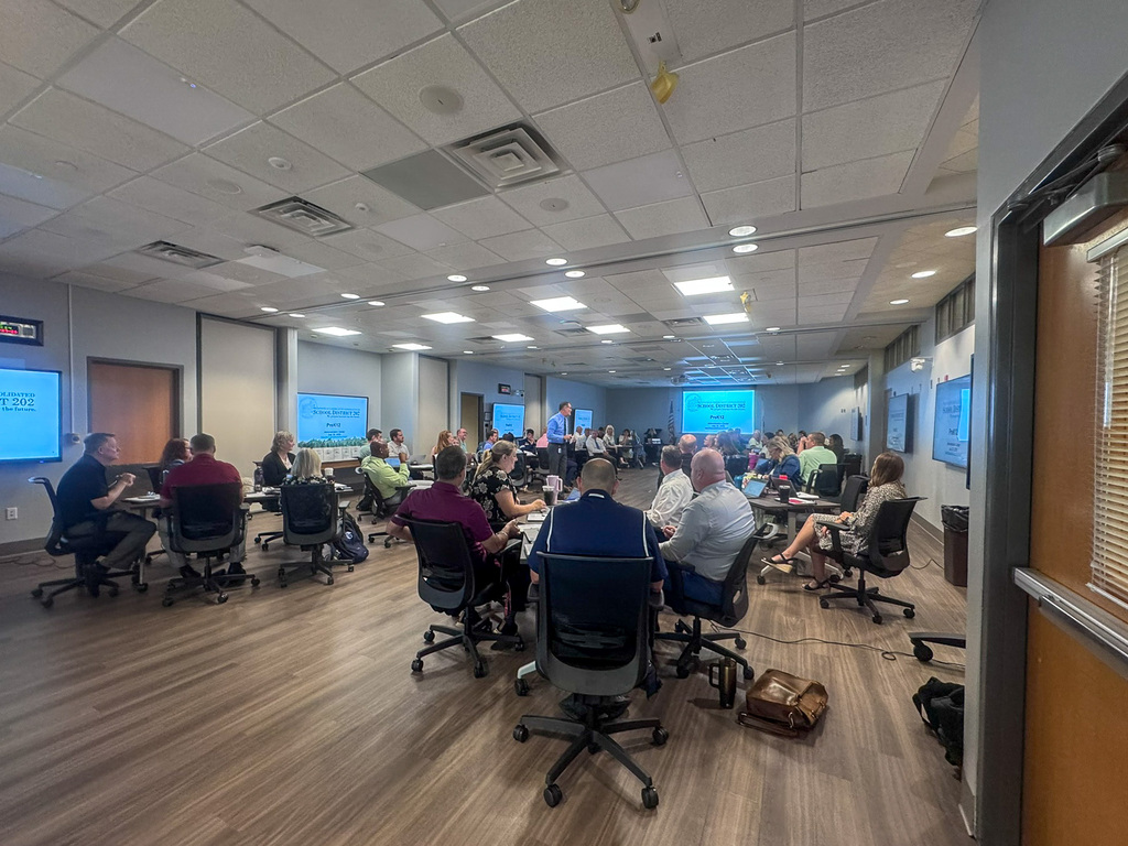 staff gathered in big room for meeting