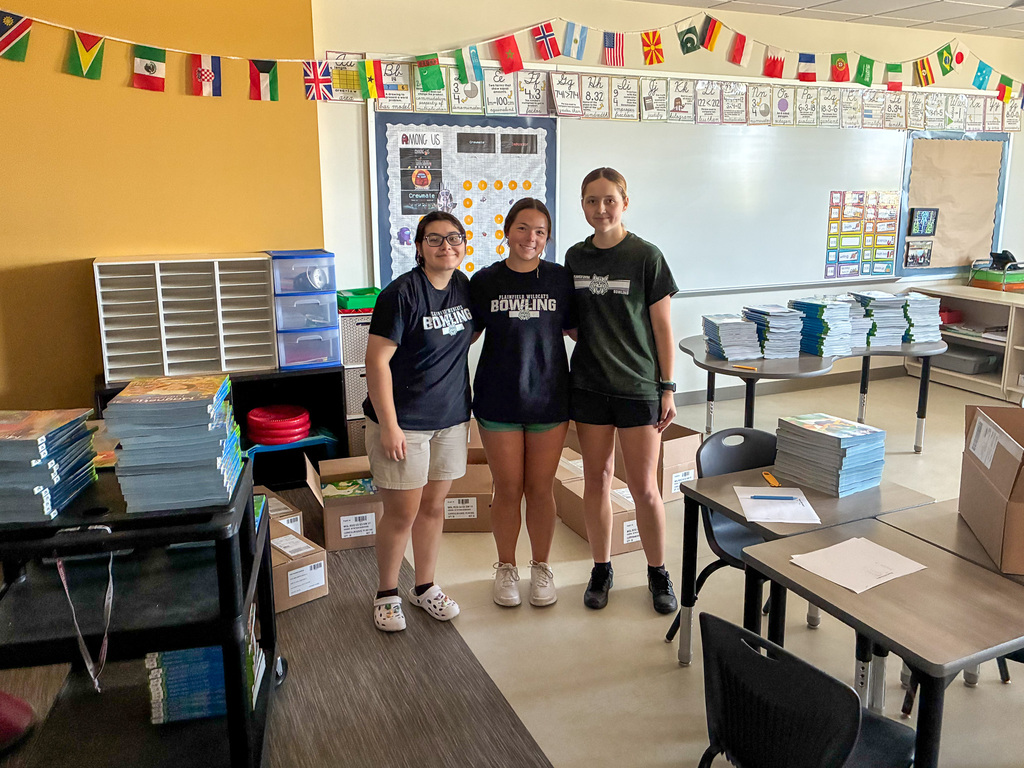 three high school girls stand in classroom