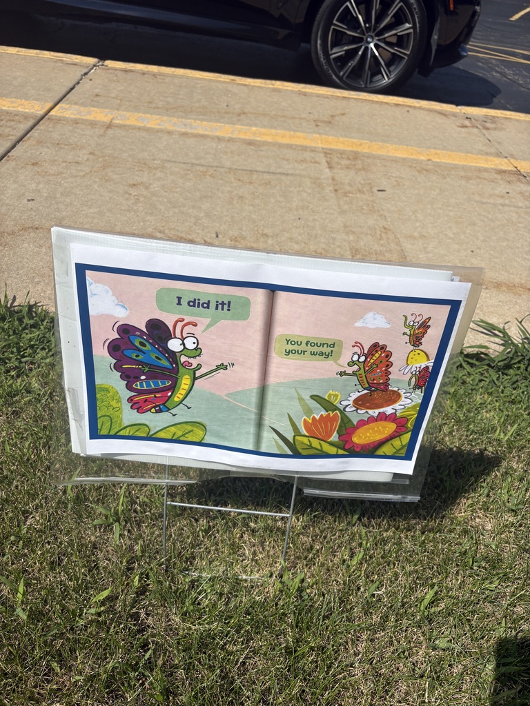 A page of a picture book displayed outside.