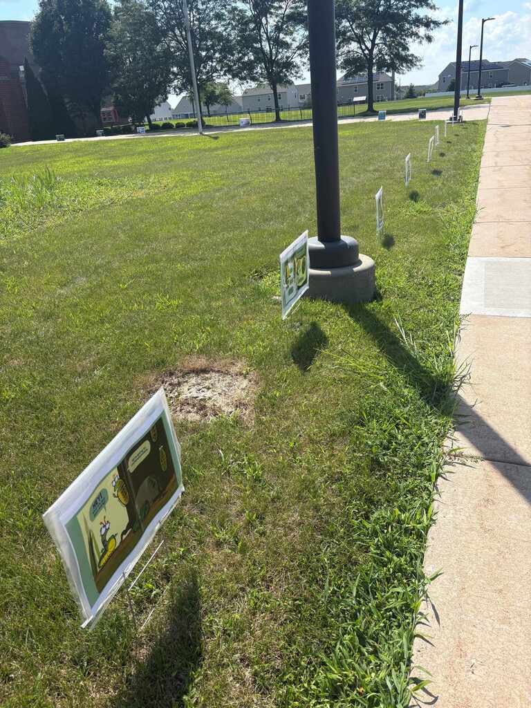 Signs in a row with pages of a picture book.