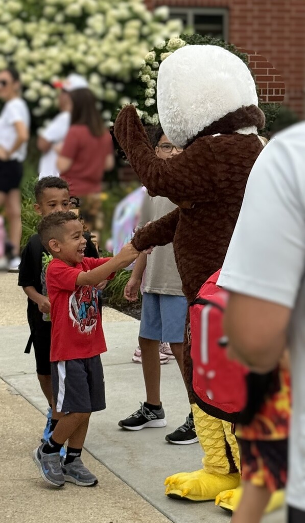 kid high fiving mascot