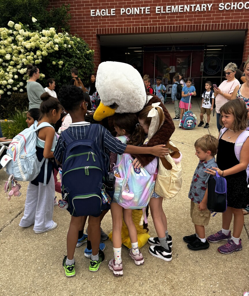 kids hugging mascot