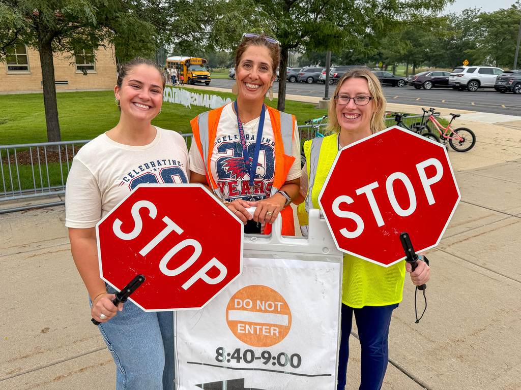 staff outside with stop signs