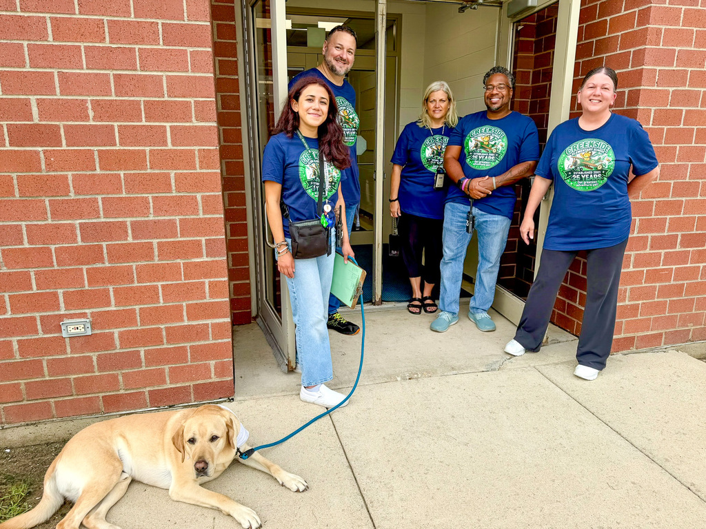 staff and facility dog Spencer outside