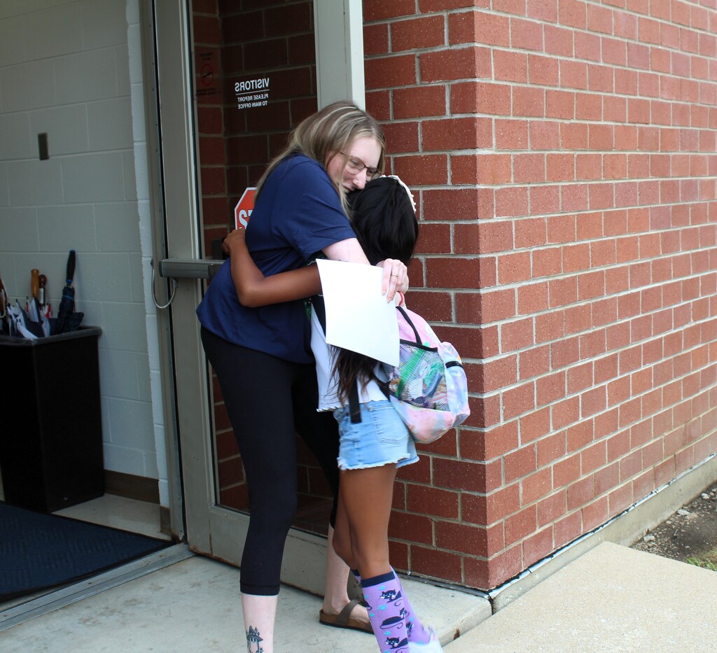 teacher and student hug