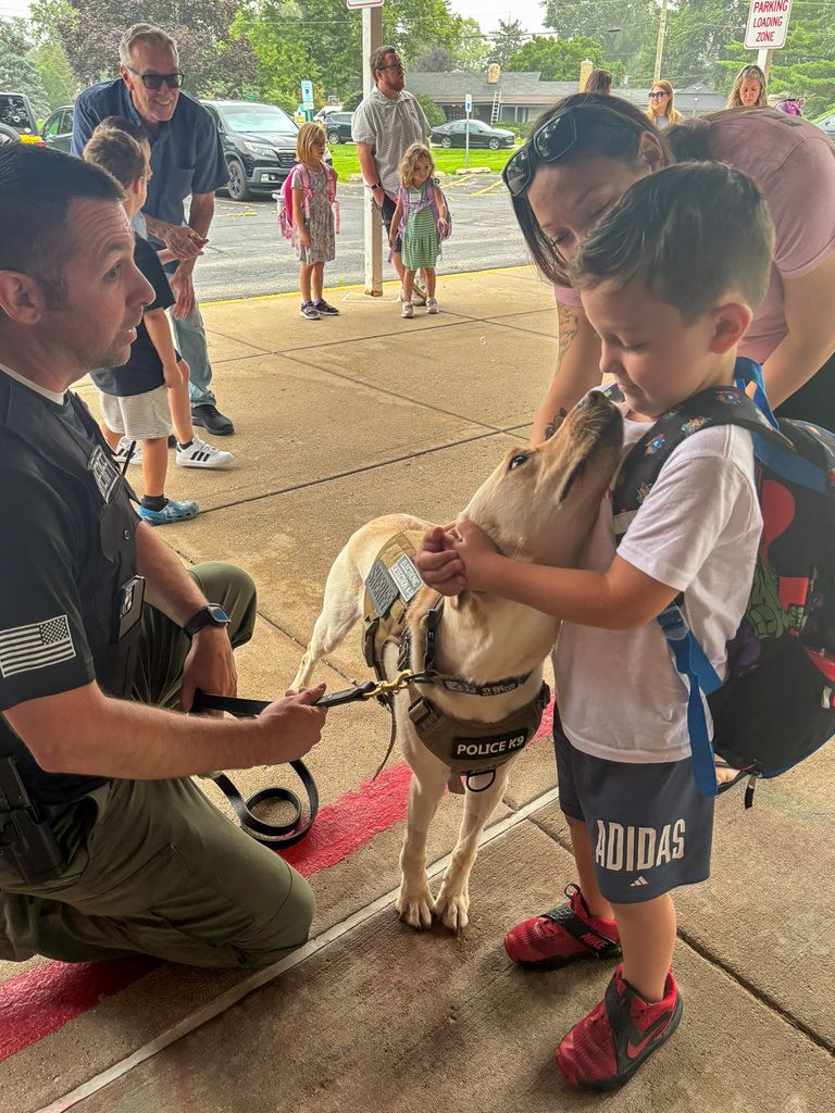 boy pets police dog