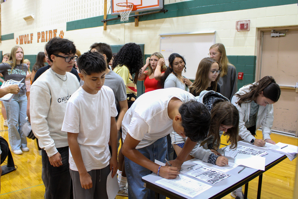 group of students signing forms