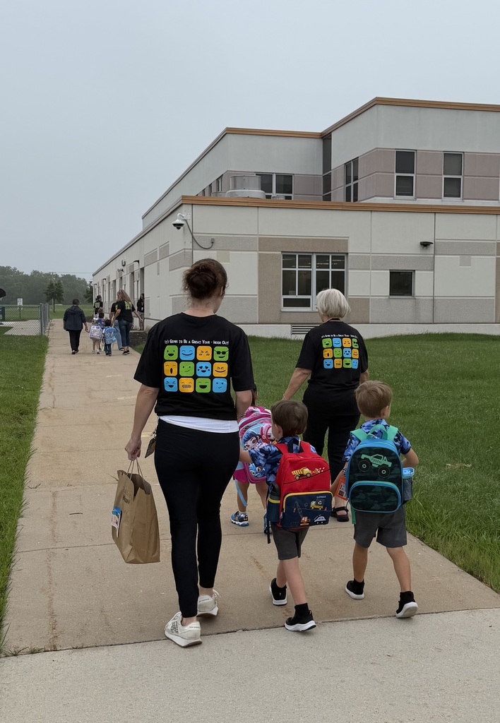 students and teachers walking into preschool 