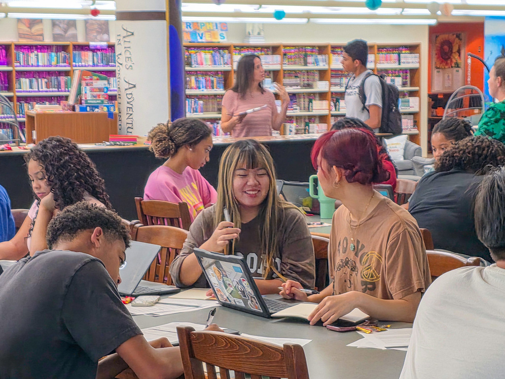 group of students using computers, writing