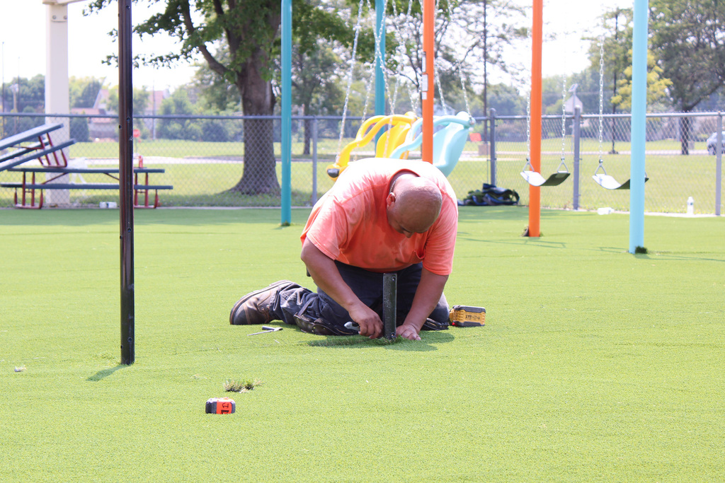 man working on newly installed turf