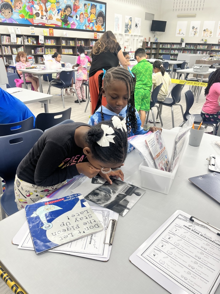 Students inspect books for damage.
