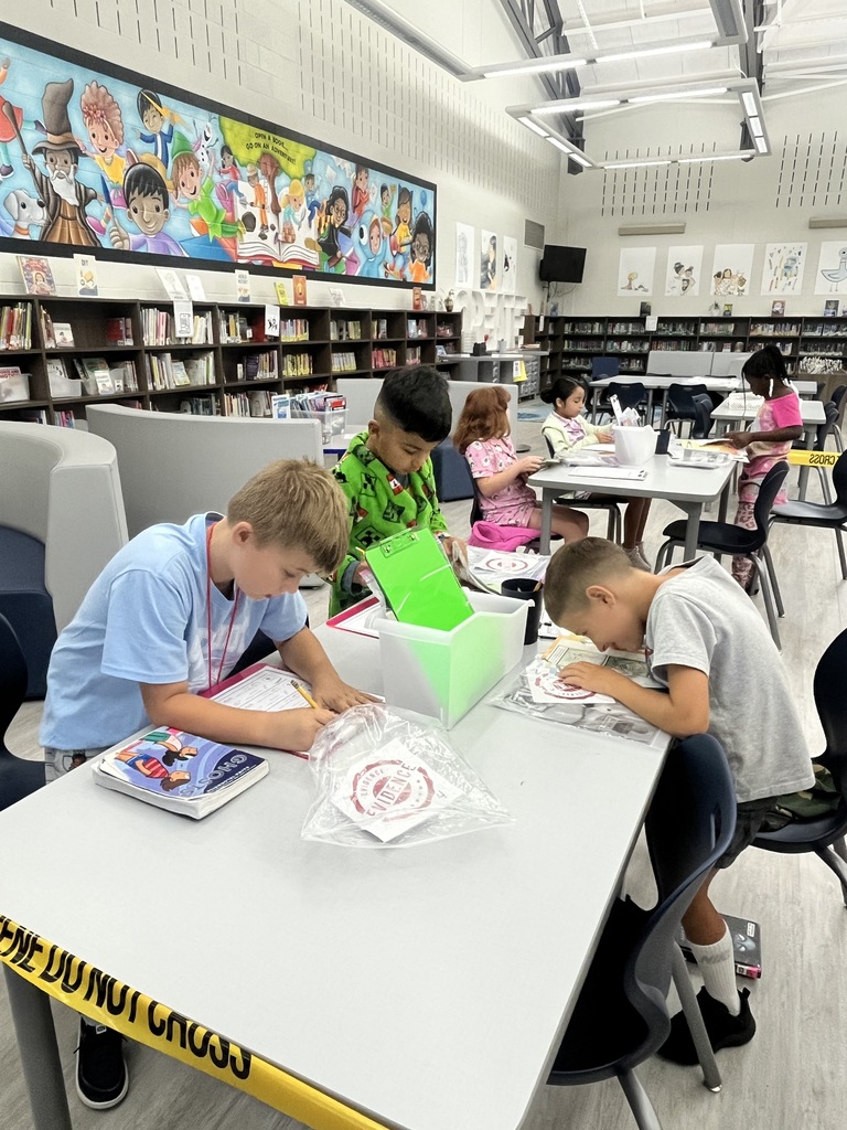 Students inspect books for damage.