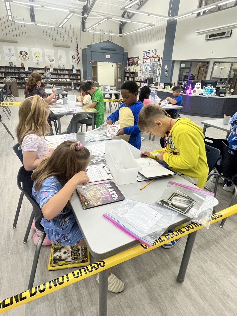 Students inspect books for damage.