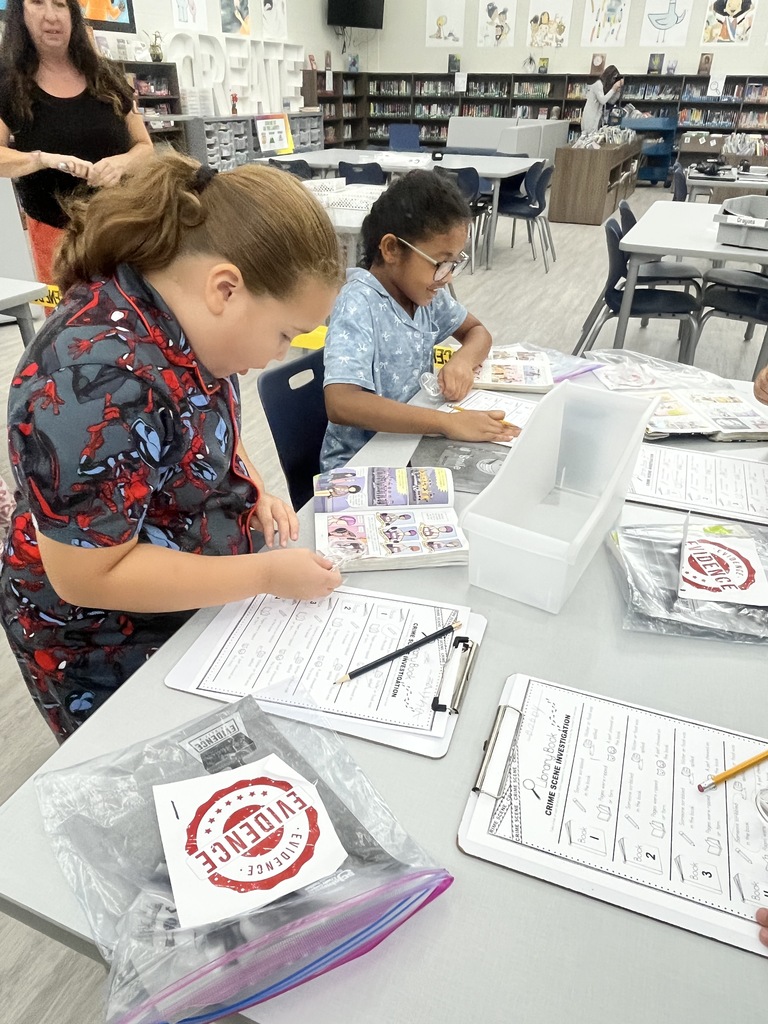 Students inspect books for damage.