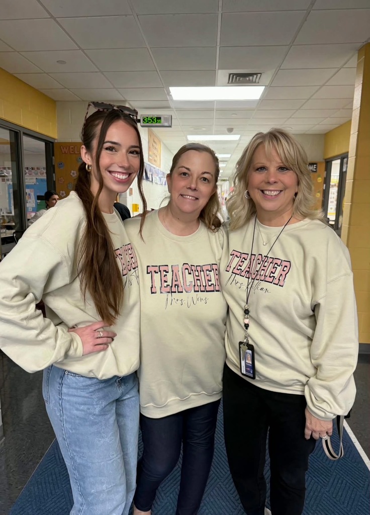 Three teachers with 3rd grade sweat shirts standing in a row smiling.