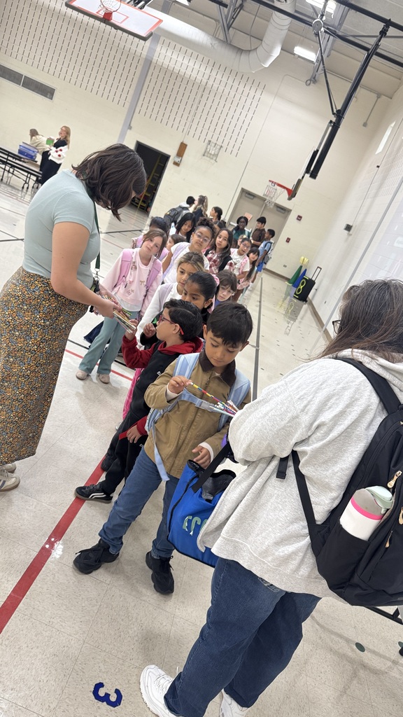 students stand in line in gym