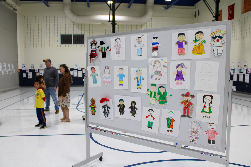 white board with colorful hand drawn pictures of people in cultural dress
