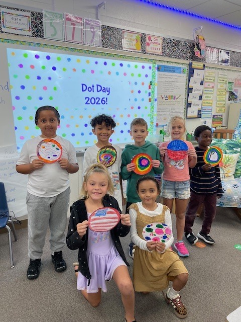 Creekside ES students holding their artwork