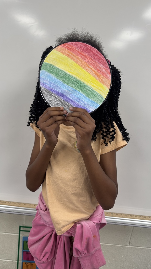 Creekside ES students holding their artwork