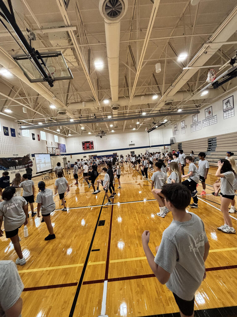 students and parents in gym for Eagle Dash