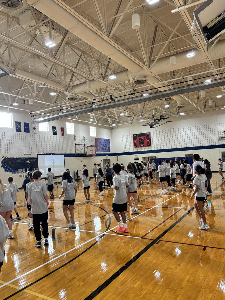 students and parents in gym for Eagle Dash