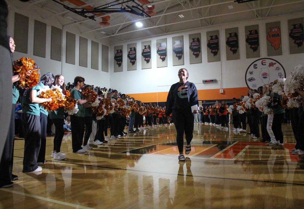 student walking into gym through two lines of students