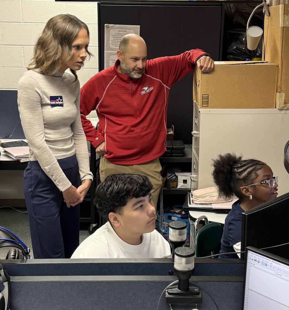 IL State Rep Jessica Dixon Heitman and principal Novinski watch students work on computer
