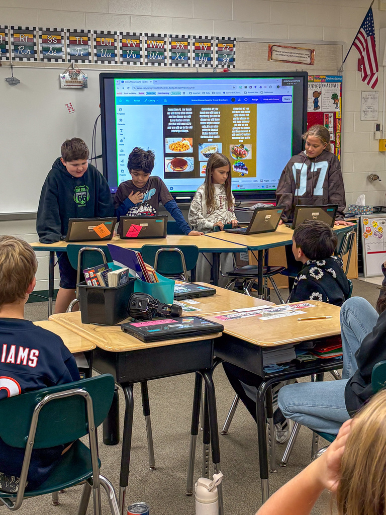 group of fourth graders present on project in front of classmates