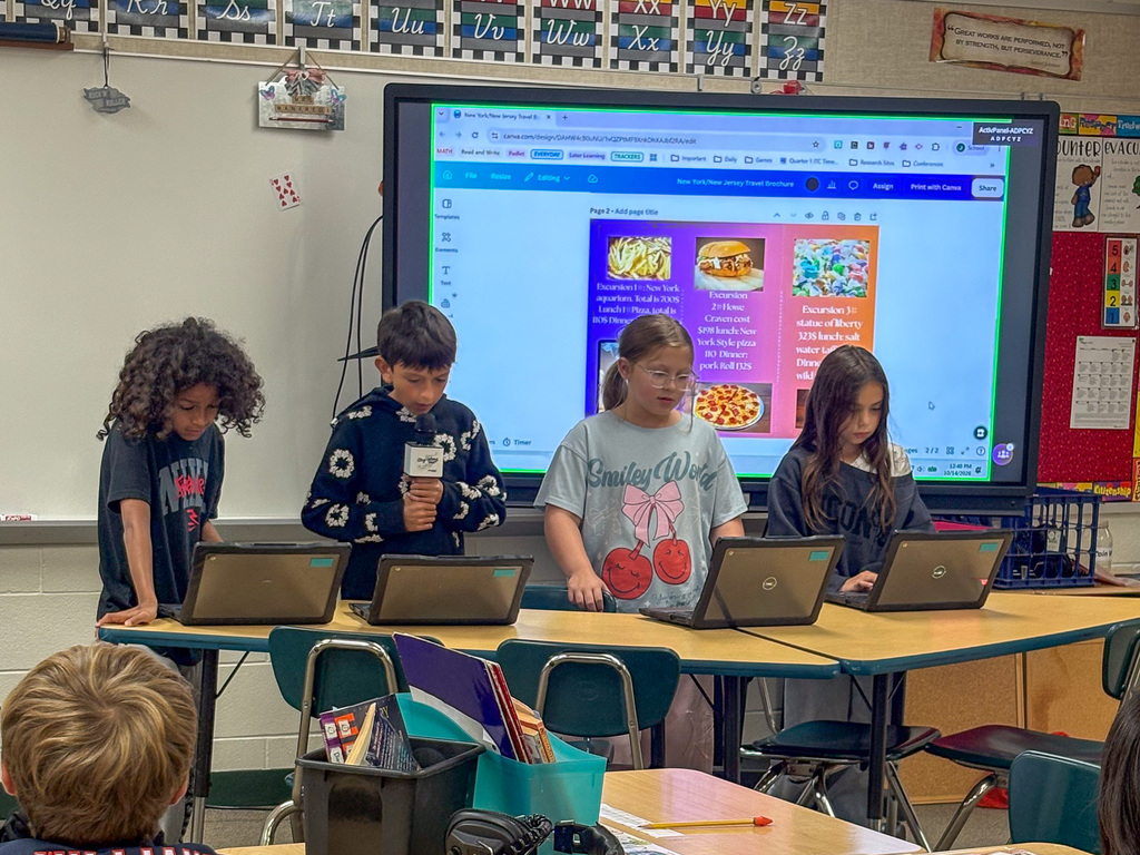 group of fourth graders present on project in front of classmates