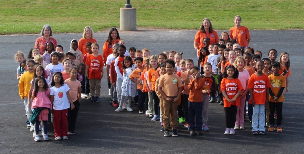 students and staff take pictures outside in orange shirts to show support for Unity Day