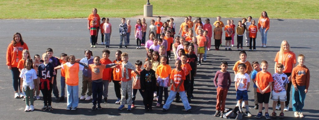 students and staff take pictures outside in orange shirts to show support for Unity Day
