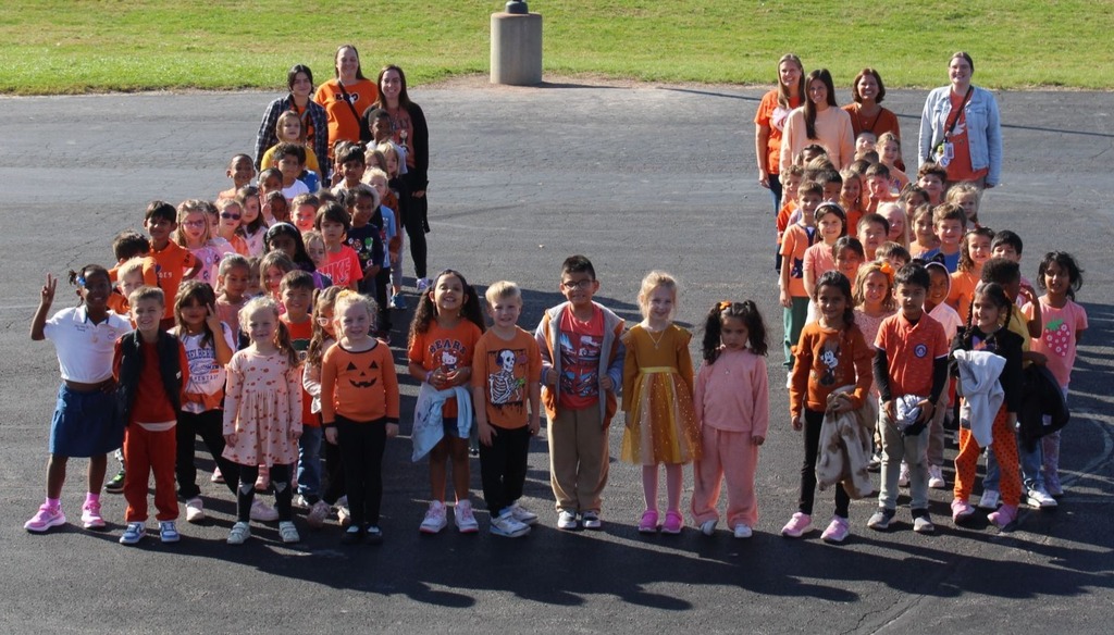 students and staff take pictures outside in orange shirts to show support for Unity Day