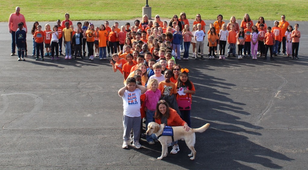 students and staff take pictures outside in orange shirts to show support for Unity Day