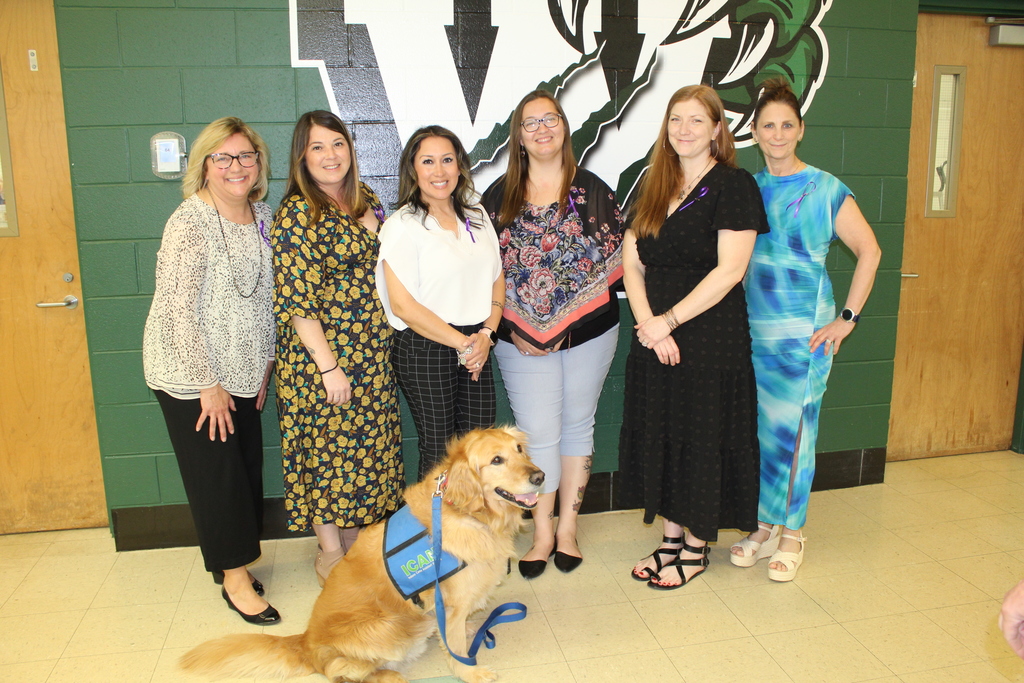 five women lined up with service dog Leroy in front