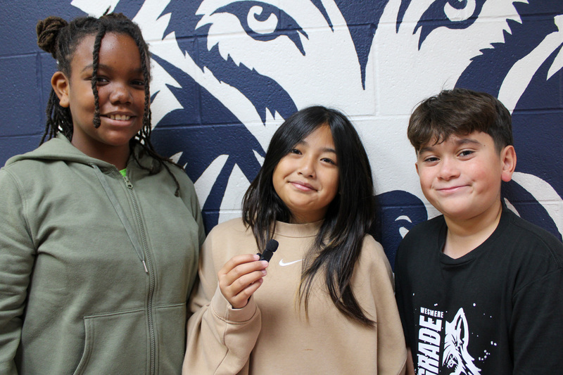 three students stand together