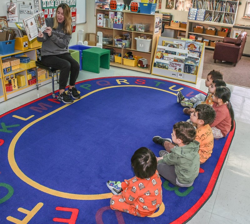 BMLC students sit on carpet during reading time